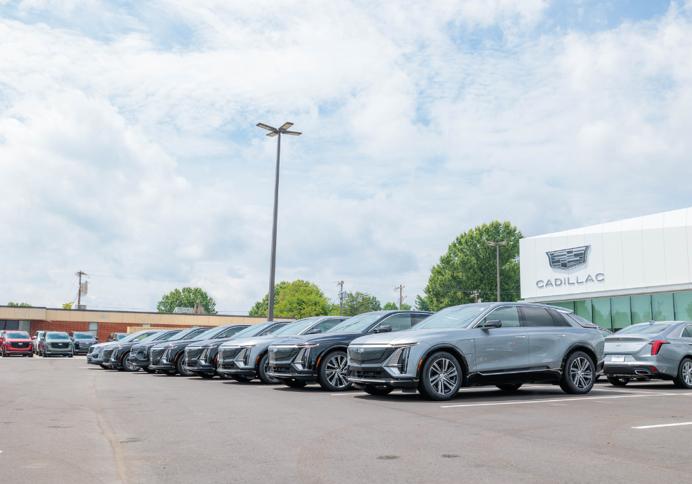 Lineup of Cadillac cars outside of the Flow Cadillac dealership